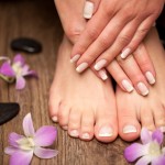 Relaxing pink manicure and pedicure with a orchid flower